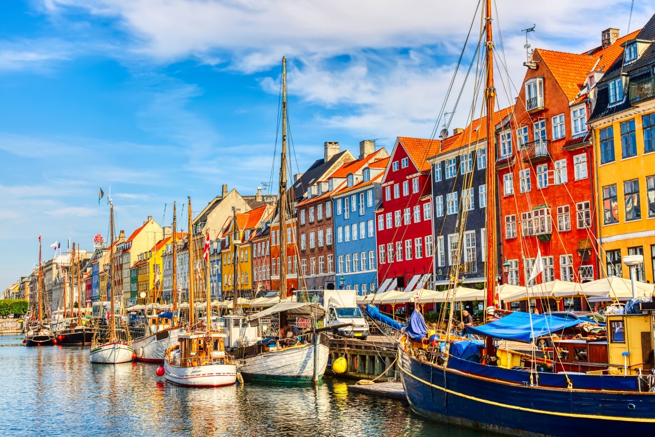 Famous old Nyhavn port in the center of Copenhagen, Denmark during a sunny day.