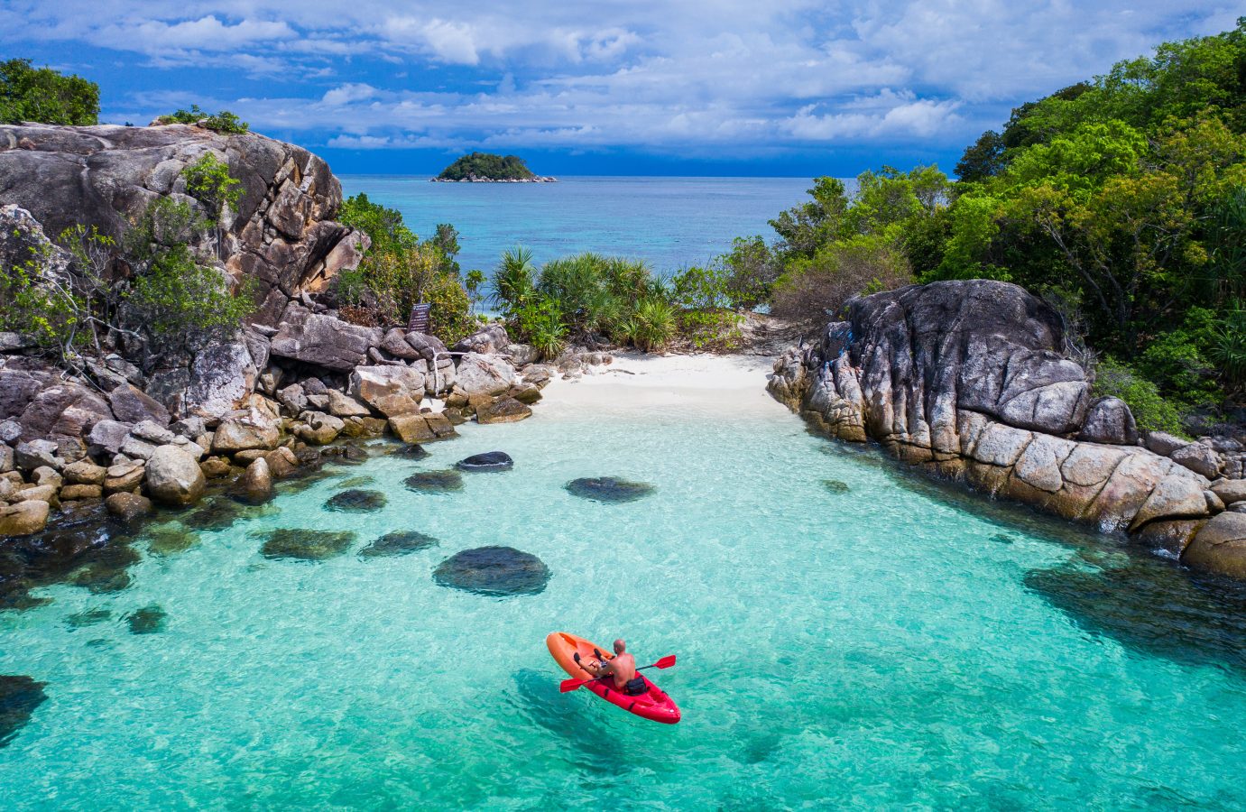 Aerial drone view of kayak in clear lagoon sea water during summer day near Koh Lipe island in Thailand (one of the cheapest destinations to fly to for 2025).
