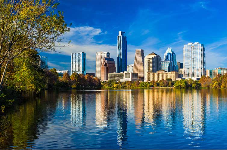 Austin Texas skyline in background and body of water in foreground.