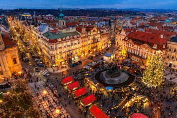 View from above on traditional Christmas market at Old Town Square illuminated and decorated for holidays in Prague – popular tourist destination, capital of Czech Republic and fifth most visited European city.