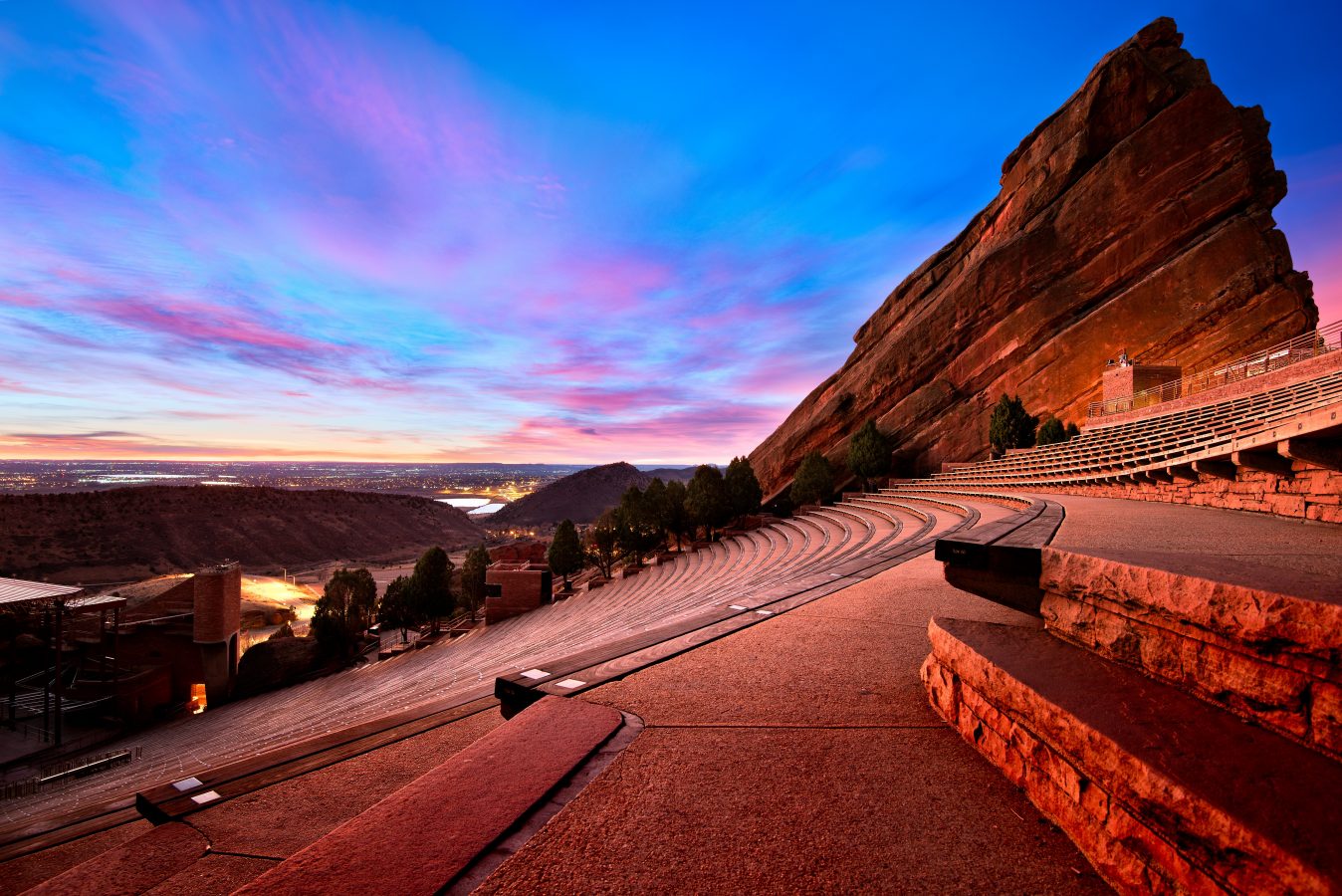 An empty Red Rocks Amphitheatre, near Denver, one of the cheapest summer destinations this year, at twilight with a purple and blue sky.