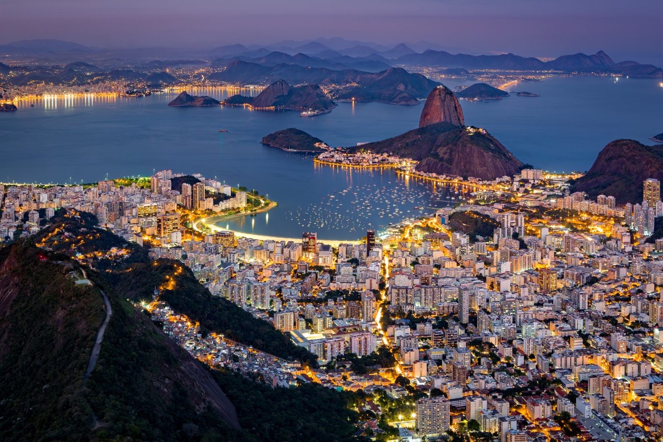 Aerial view over Rio de Janeiro as viewed from Corcovado. The famous Sugar Loaf mountain sticks out of Guanabara Bay.