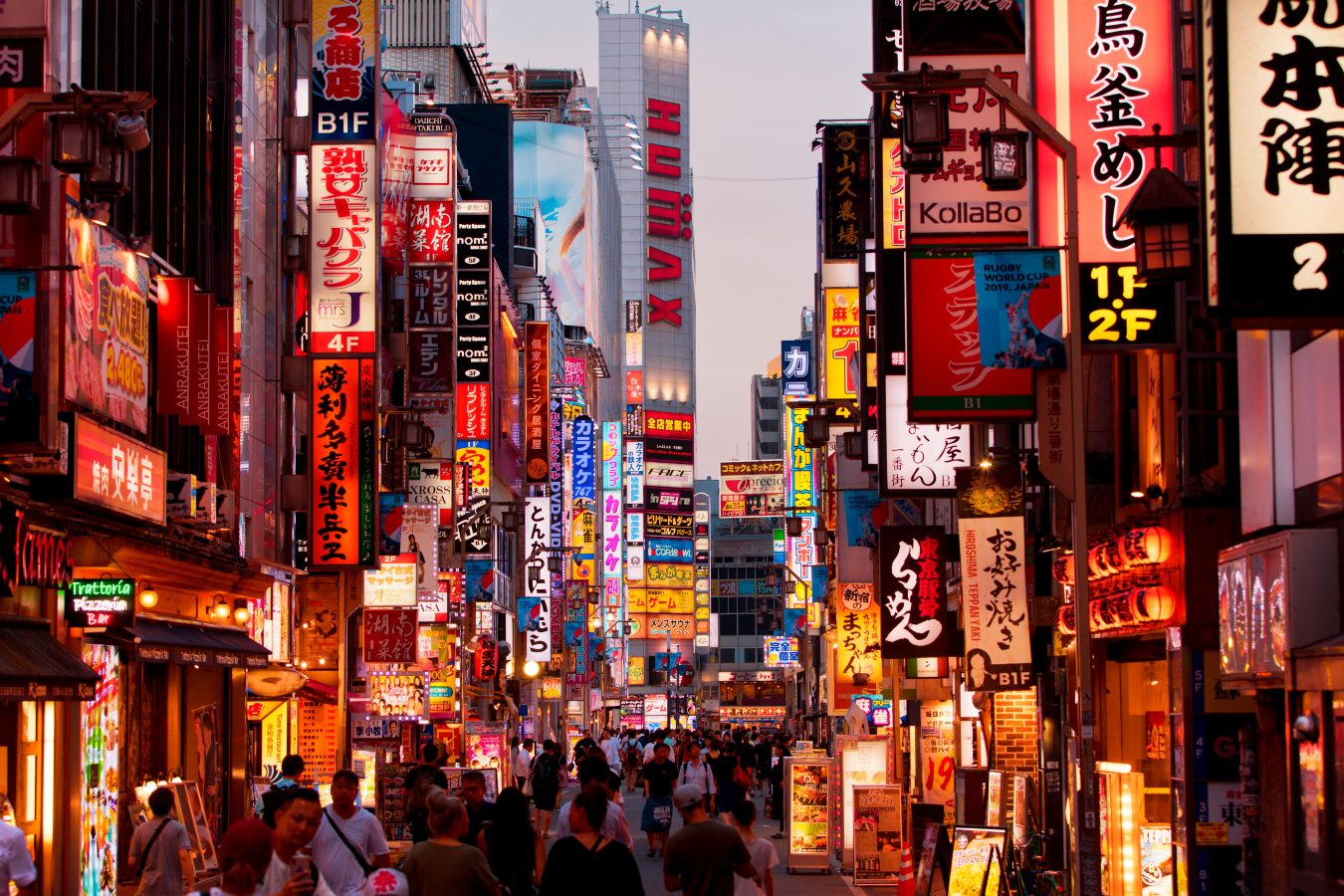 Lit up signs on a Tokyo, Japan street at night.