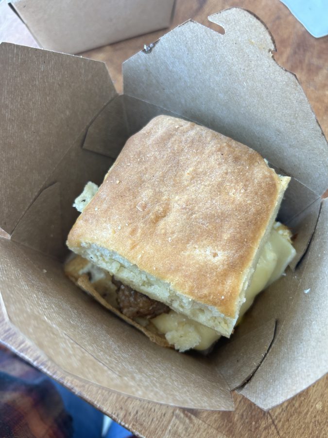 Top down look at the huge breakfast sandwiches at Lulu's Bakery and Pantry. Large square cut biscuit with egg, cheese, and sausage.