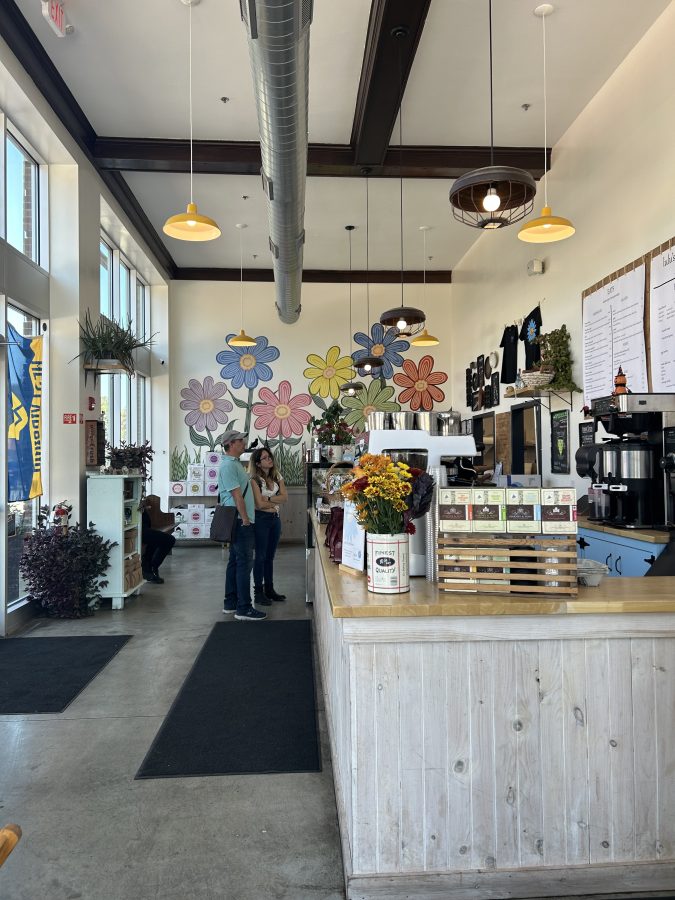 Inside at Lulu's Bakery and Pantry in Salem, Massachusetts with a flower mural on the wall.