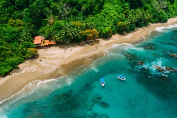 Aerial view of a beach in Costa Rica with the jungle behind the sandy beach. Costa Rica is a popular place to travel to and is one of the cheapest destinations for 2025.