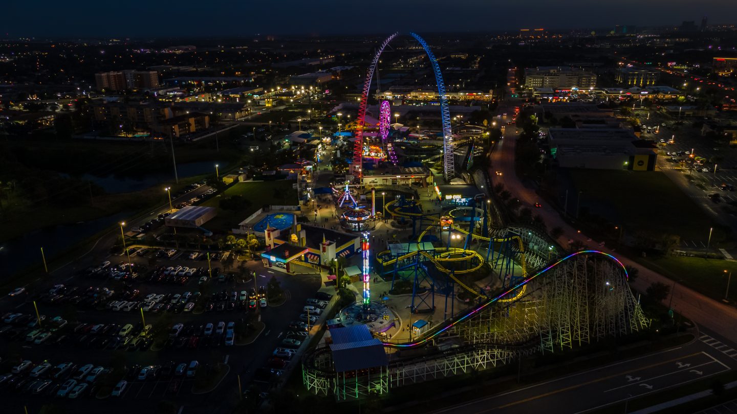 Nighttime aerial view of a theme park in Orlando, Florida. Orlando is the place to travel to for theme parks like Disney, Universal, and more!