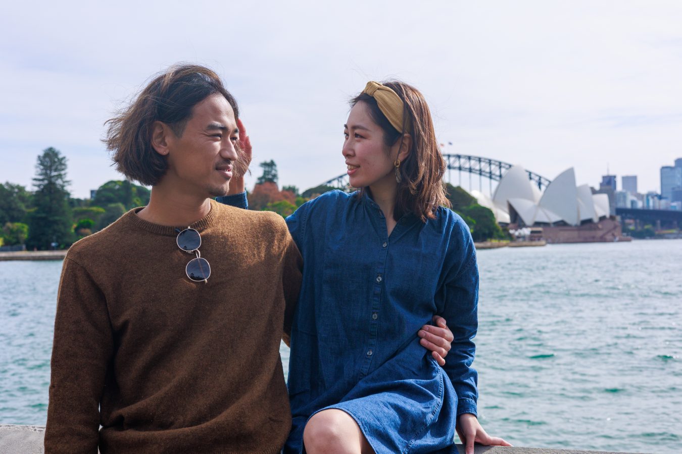 Two student travels pose with Sydney Opera House behind them.