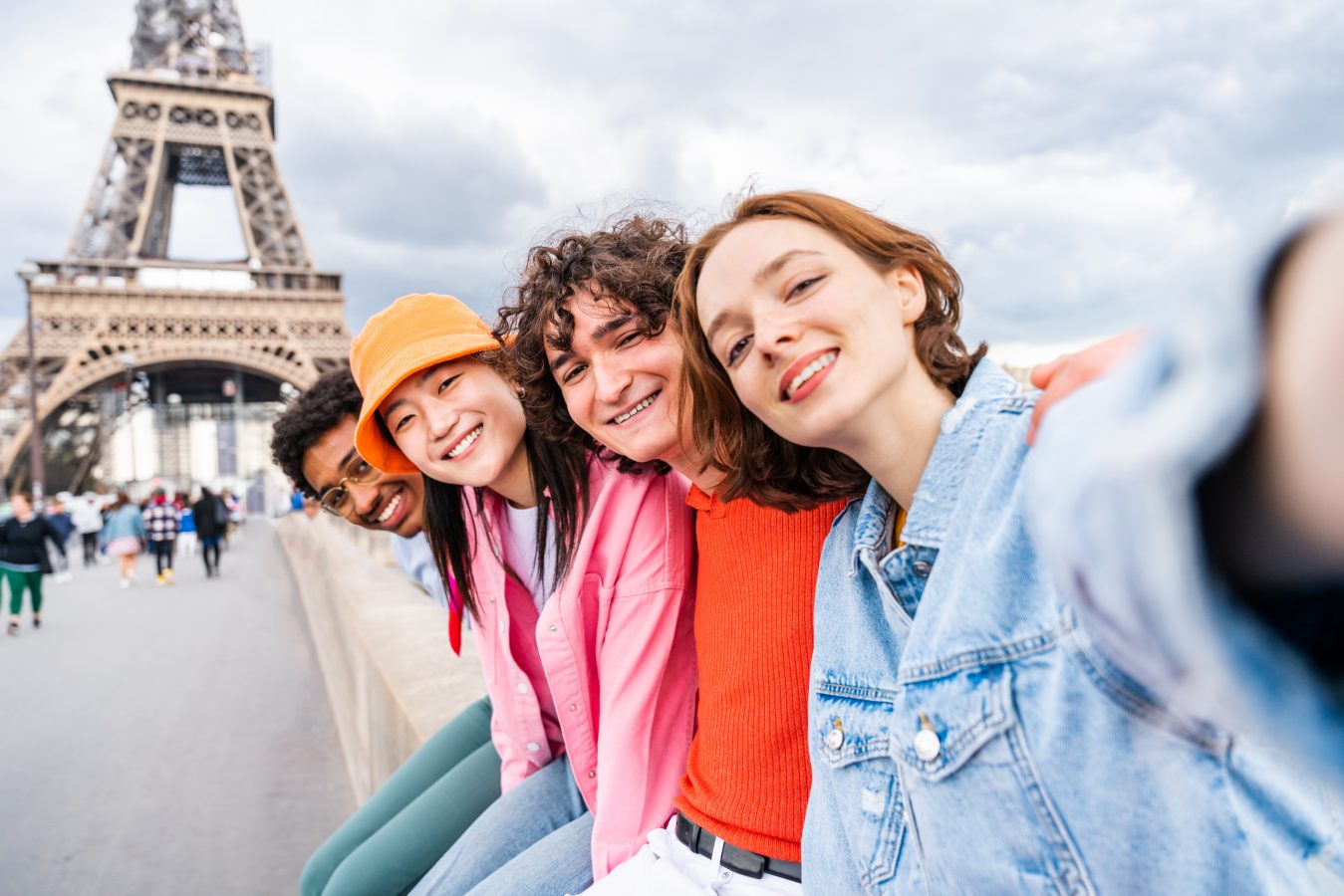 Group of young happy friends visiting Paris and Eiffel Tower, Trocadero area and Seine river