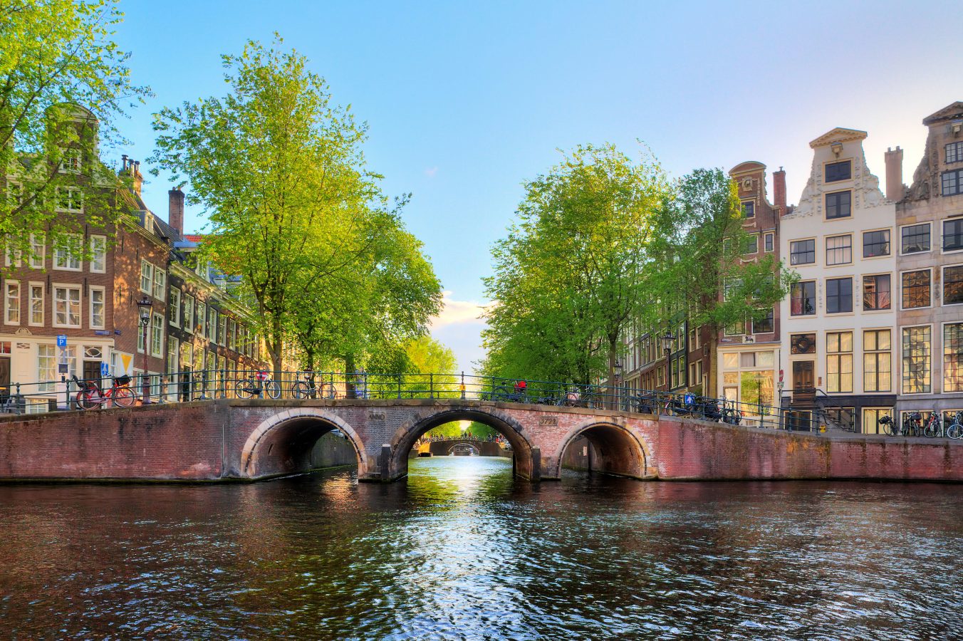 Bridge over the Leidse canal at the Patricians' or Lords' canal (Herengracht) in Amsterdam in spring. Walking the canals is one of the cool cheap things to do in Europe.