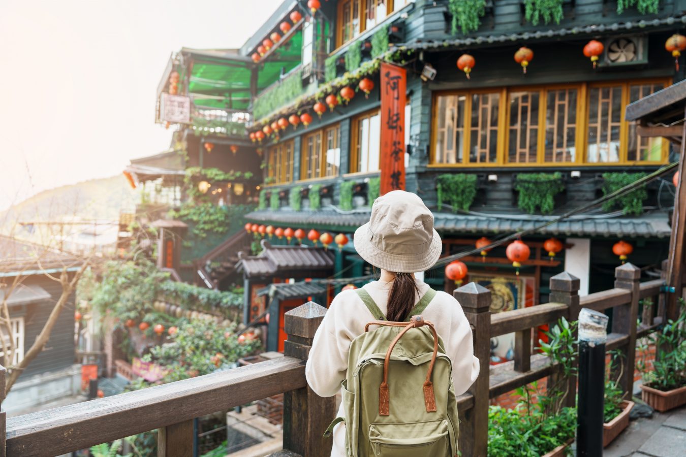 Traveler visiting Taiwan, sightseeing in Jiufen Old Street village with Tea House background near Taipei city.