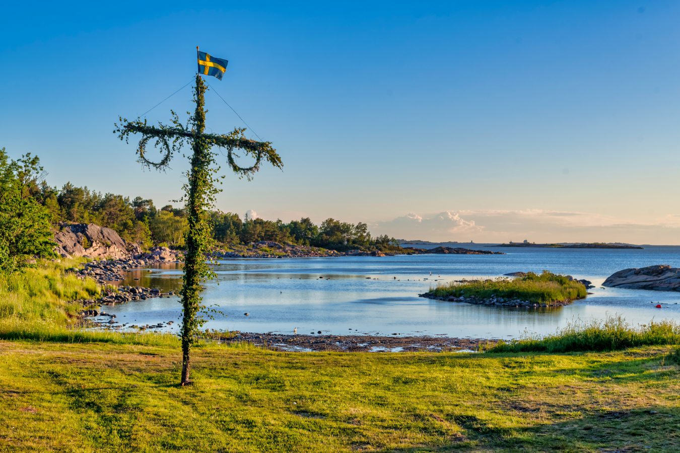 Sunrise of a classic midsommer pole at the coast line of Roslagen, Sweden atchipelago