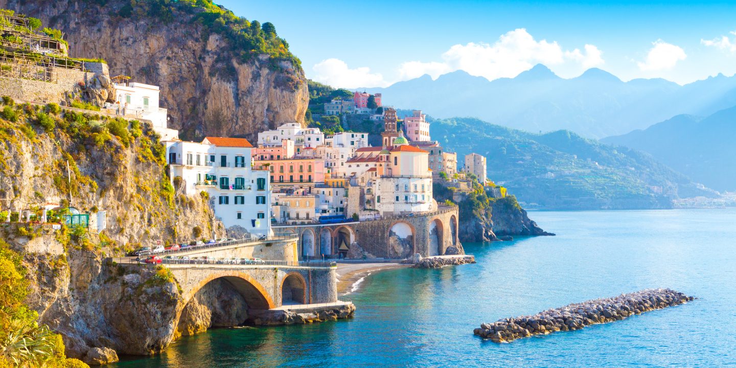 Sunny view of Amalfi cityscape on coast line of the Mediterranean Sea.