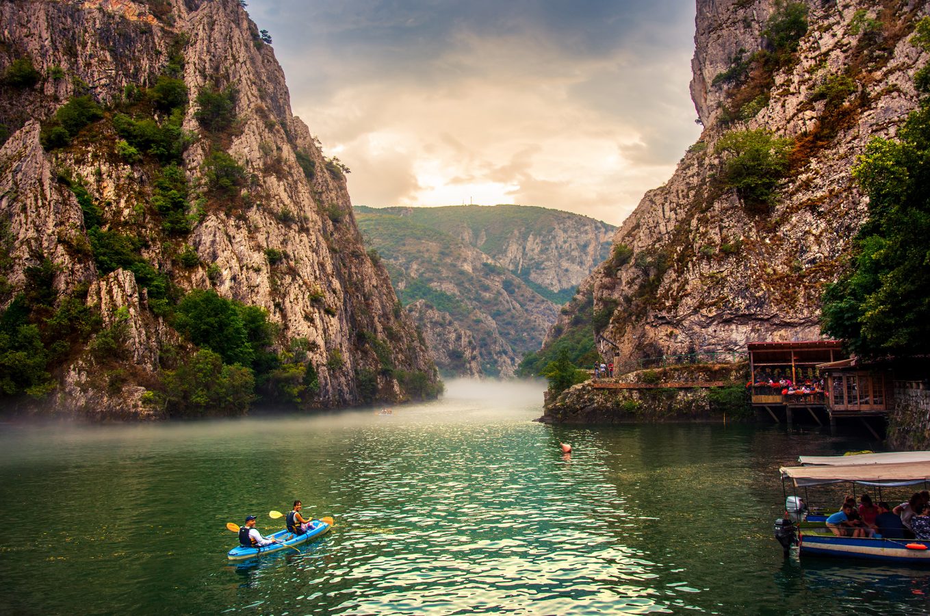 Canyon Matka near Skopje with people kayaking and amazing foggy scenery. North Macedonia is an underrated destination in Europe that's on the top of our list for trips to take in 2025.