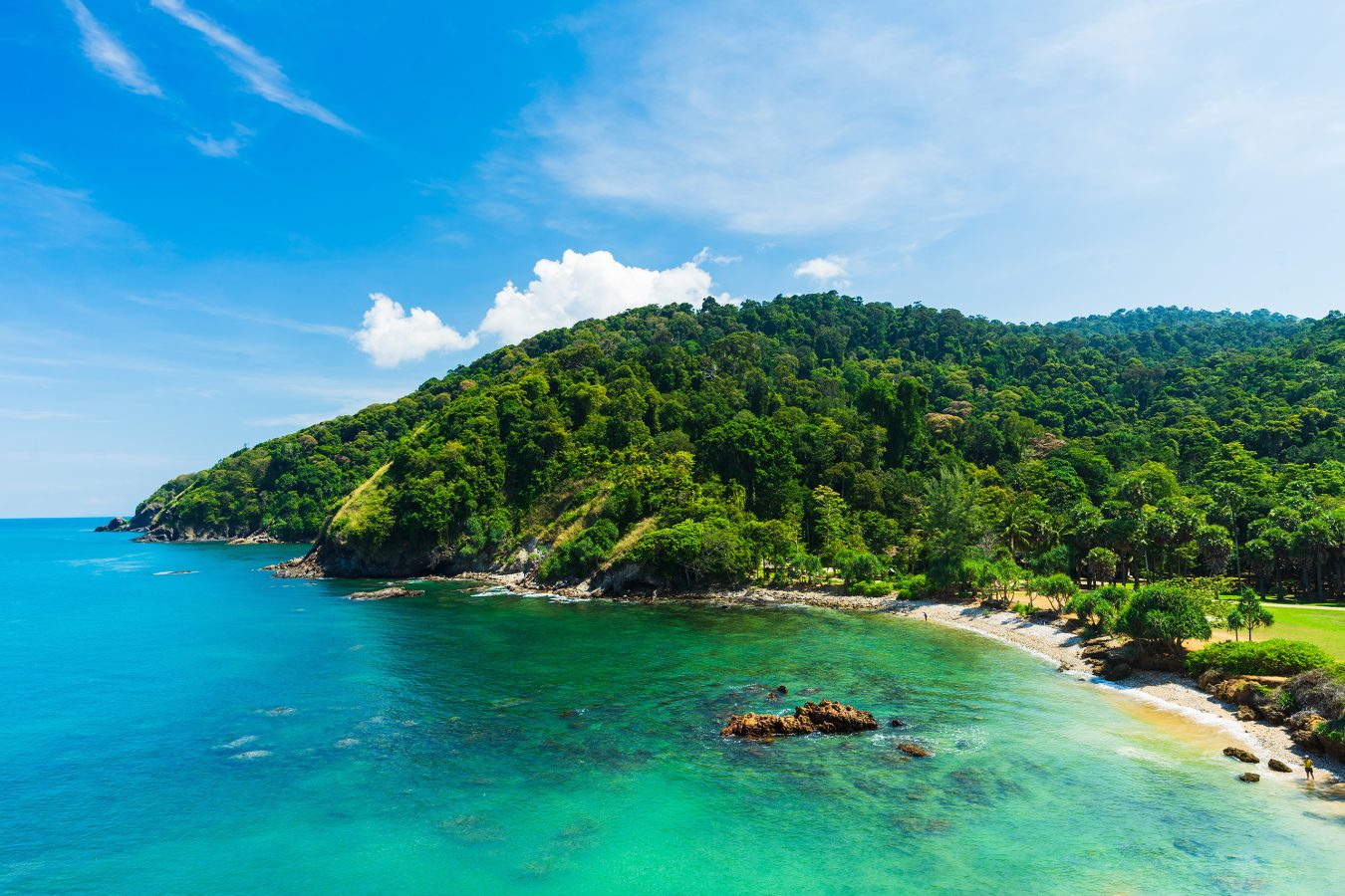 Sunny seascape view with clear sea, green forest and blue sky on koh Lanta island in Thailand. Thailand is a top trips to take in 2025