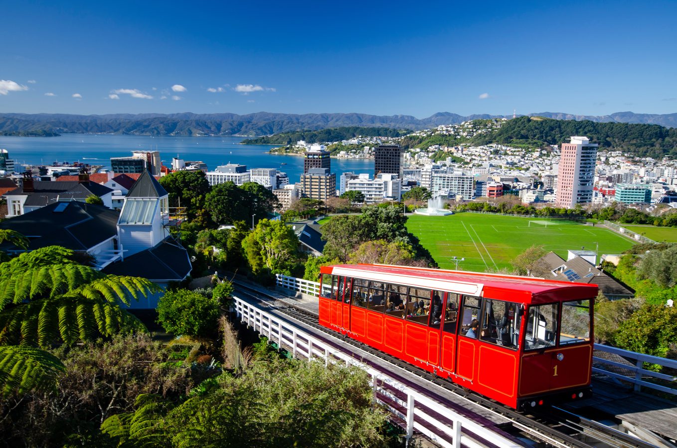 Red tram riding down the hillside in Wellington, New Zealand - a top destination for 2025.